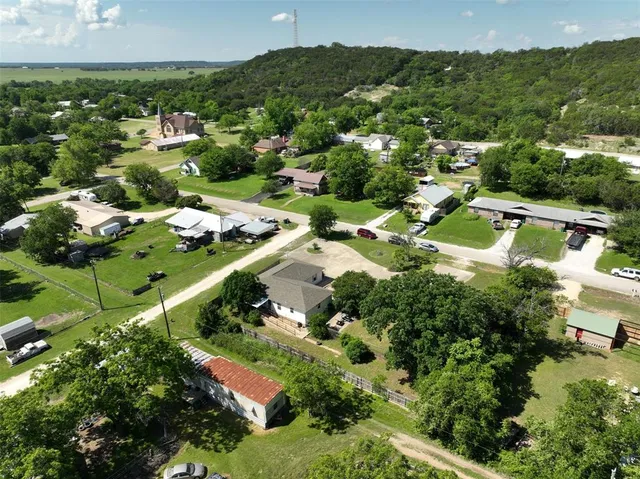 an aerial view of residential houses with outdoor space and river