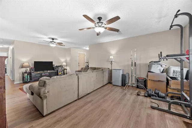 a living room with furniture and view of kitchen