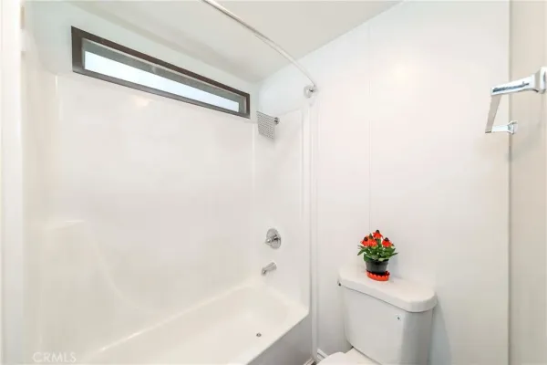 a bath tub sitting next to a white toilet
