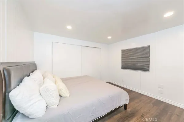 a bedroom with a bed and a painting