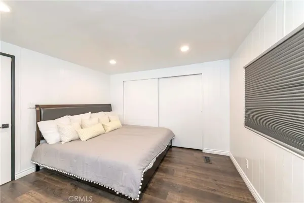 a bedroom with a bed and a walk in closet