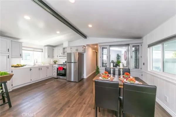 a living room filled with furniture and a kitchen