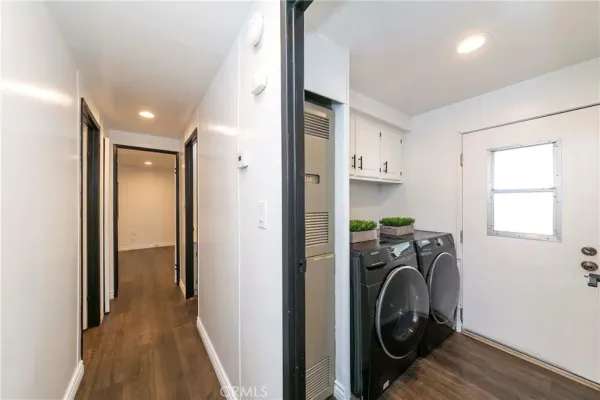 a view of a hallway with washer and dryer
