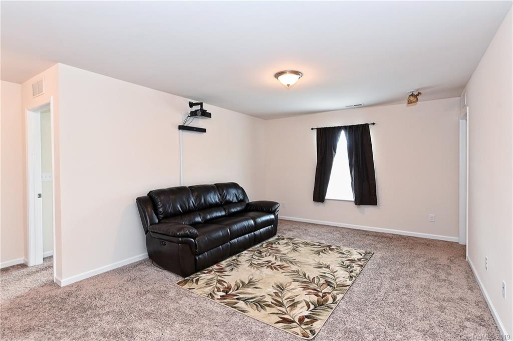1580 Spring Blossom Trail Fort Mill, SC 29708 - Photo 12 of 22 a living room with couch and a rug