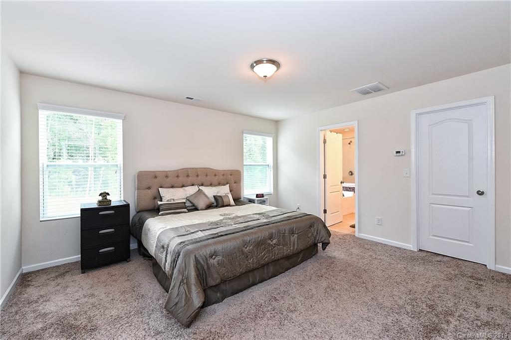 1580 Spring Blossom Trail Fort Mill, SC 29708 - Photo 13 of 22 a bedroom with a bed and a window