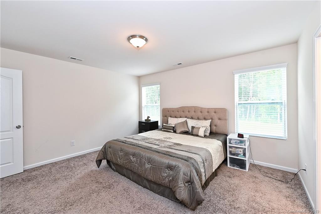 1580 Spring Blossom Trail Fort Mill, SC 29708 - Photo 14 of 22 a bedroom with a bed and a window