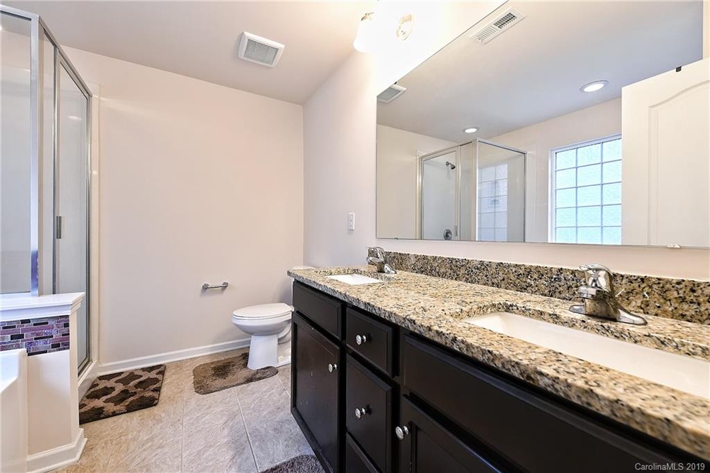 1580 Spring Blossom Trail Fort Mill, SC 29708 - Photo 15 of 22 a bathroom with a granite countertop sink a toilet and a mirror