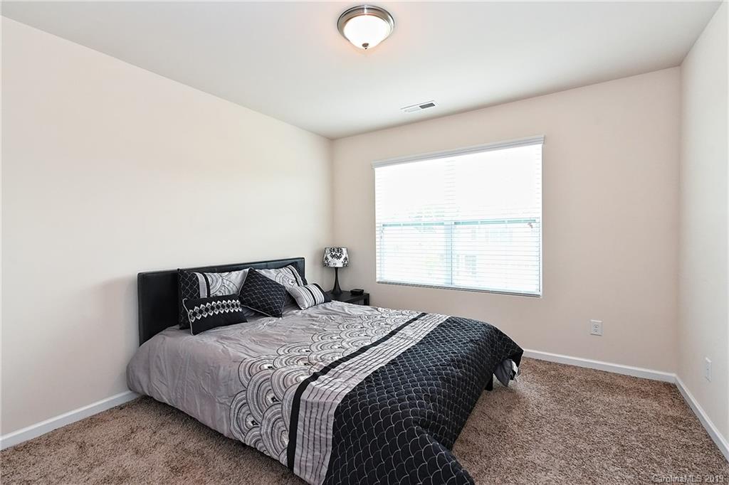 1580 Spring Blossom Trail Fort Mill, SC 29708 - Photo 17 of 22 a bedroom with a bed and a window