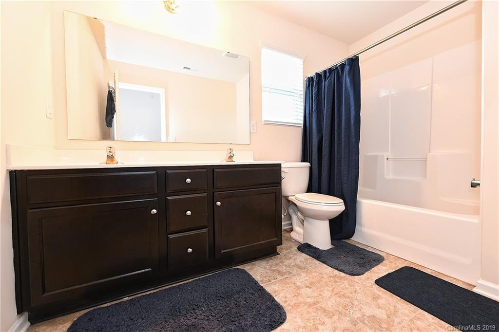 1580 Spring Blossom Trail Fort Mill, SC 29708 - Photo 18 of 22 a bathroom with a sink and a mirror