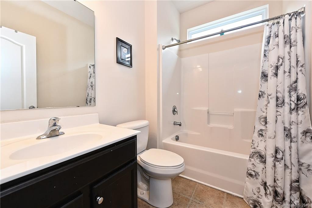 1580 Spring Blossom Trail Fort Mill, SC 29708 - Photo 4 of 22 a bathroom with a sink a toilet and a bathtub