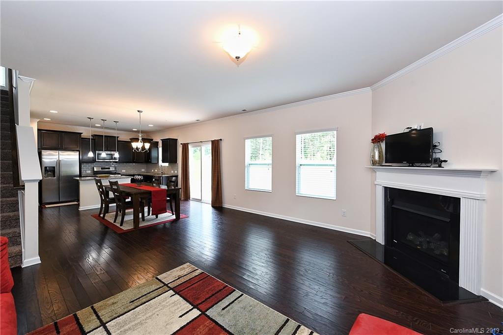 1580 Spring Blossom Trail Fort Mill, SC 29708 - Photo 7 of 22 a living room with furniture and a fireplace with wooden floor