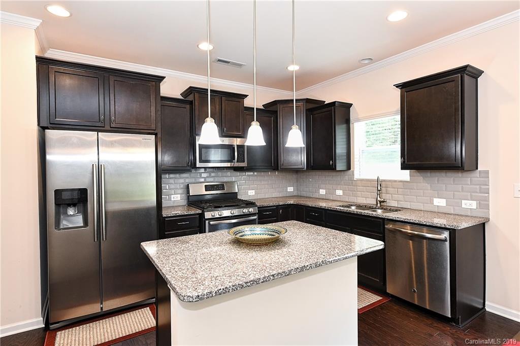 1580 Spring Blossom Trail Fort Mill, SC 29708 - Photo 10 of 22 a kitchen with stainless steel appliances granite countertop a sink refrigerator and microwave