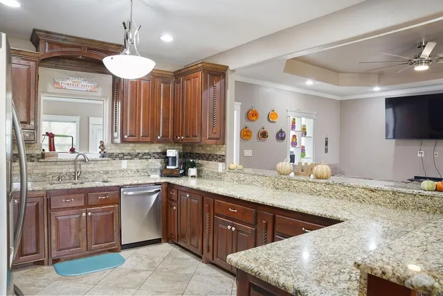 a bathroom with a granite countertop sink a large mirror and a window