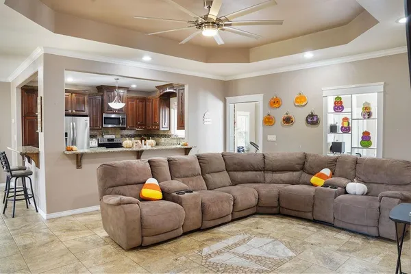 a living room with furniture and kitchen view