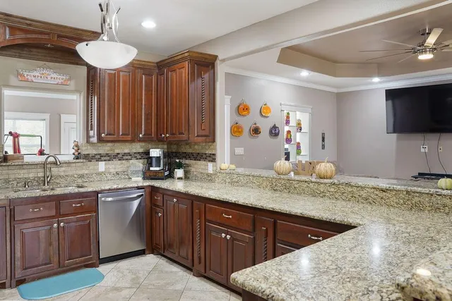 a kitchen with stainless steel appliances granite countertop a sink stove and cabinets