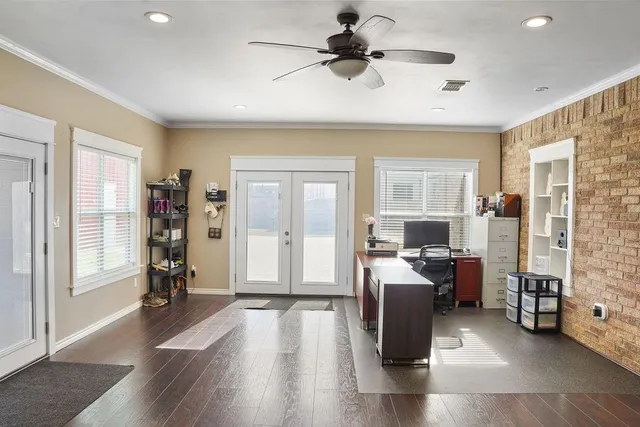 a view of a livingroom with workspace and a window