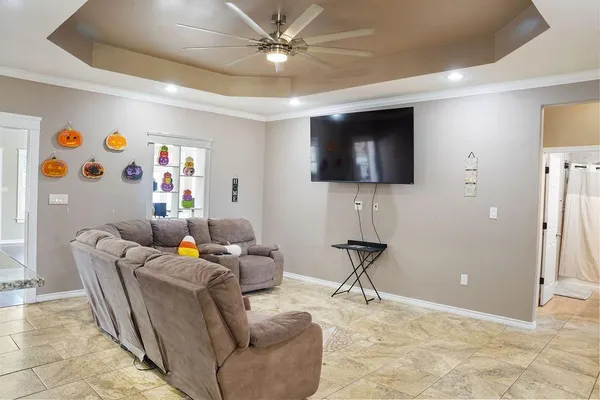 a living room with furniture and a flat screen tv