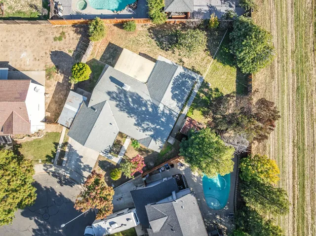 an aerial view of a house with a yard and garden