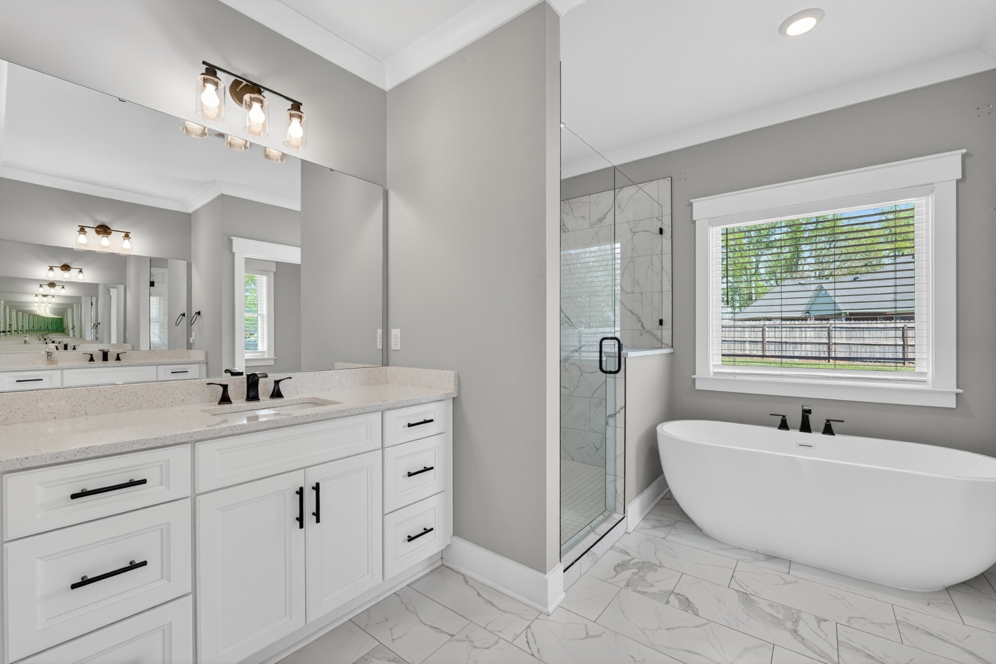 27 Hancock Road Fayetteville, TN 37334 - Photo 33 of 62 a bathroom with a double vanity sink a mirror a bathtub and next to a window