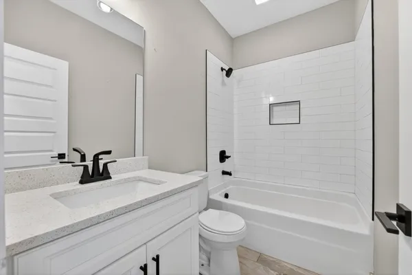 a view of walk in closet and bathroom