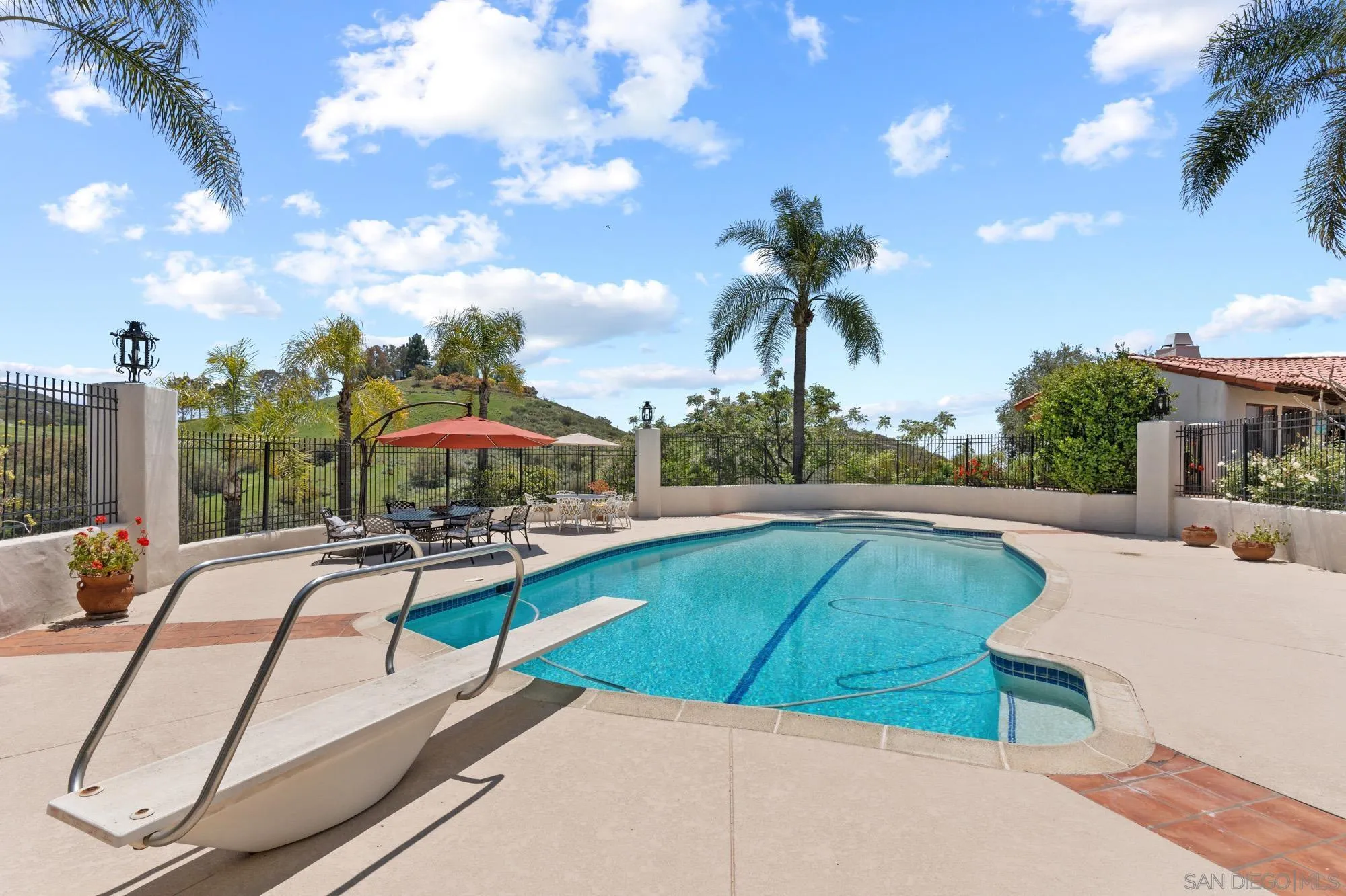 17156 Dos Hermanos Road Poway, CA 92064 - Photo 15 of 59 a view of a swimming pool with lounge chairs