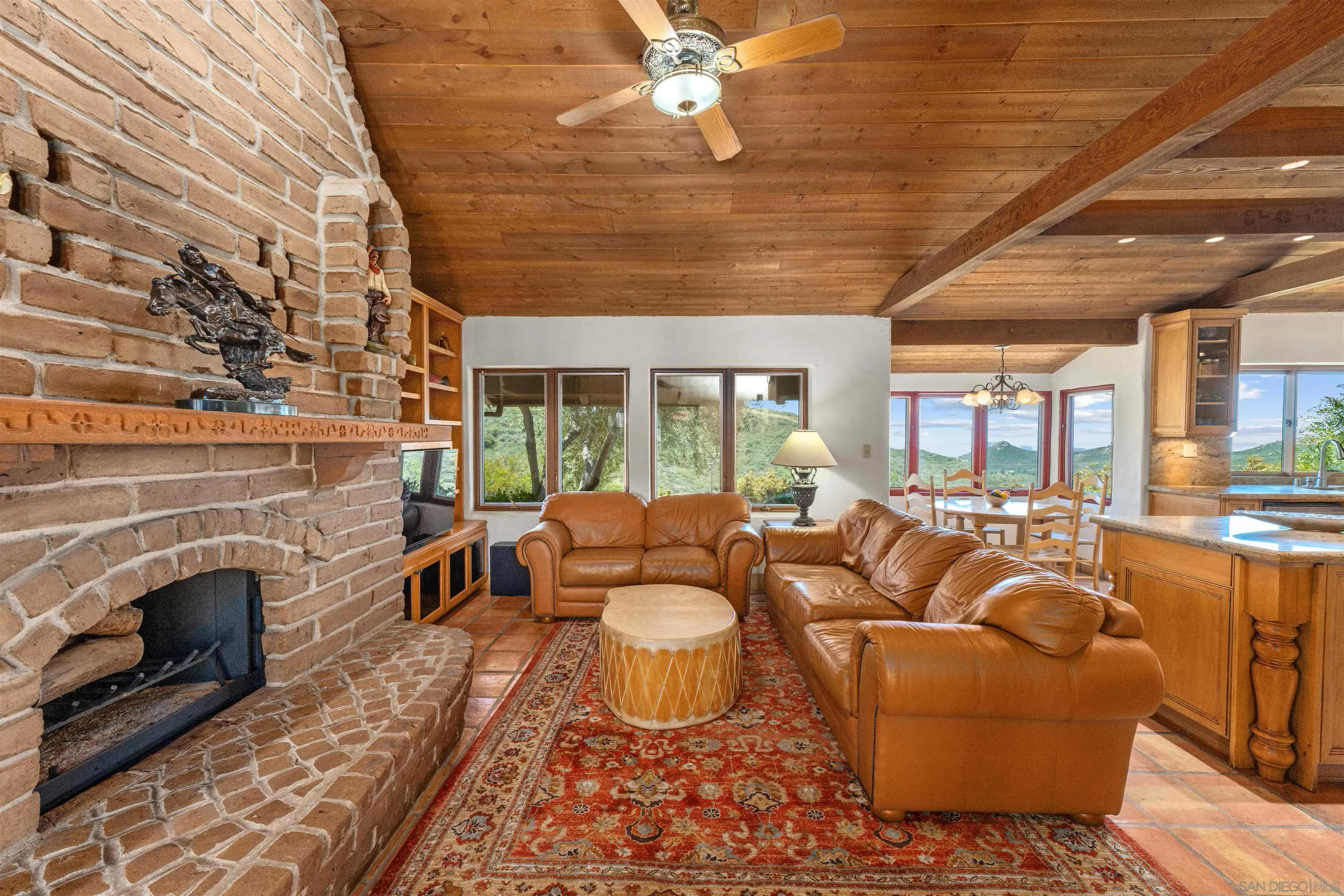 17156 Dos Hermanos Road Poway, CA 92064 - Photo 26 of 59 a living room with furniture a fireplace and a table