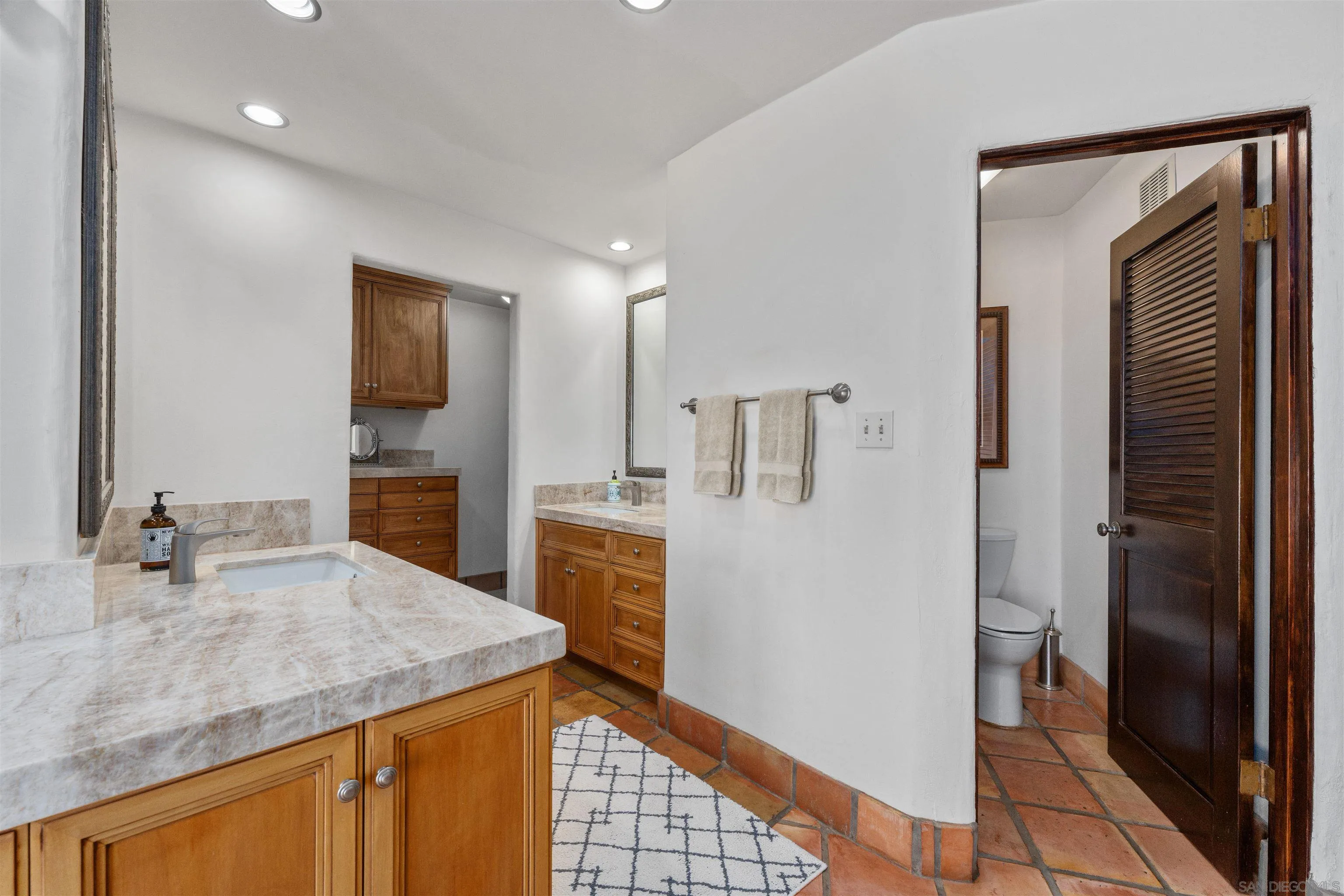 17156 Dos Hermanos Road Poway, CA 92064 - Photo 35 of 59 a kitchen with kitchen island a sink appliances and cabinets