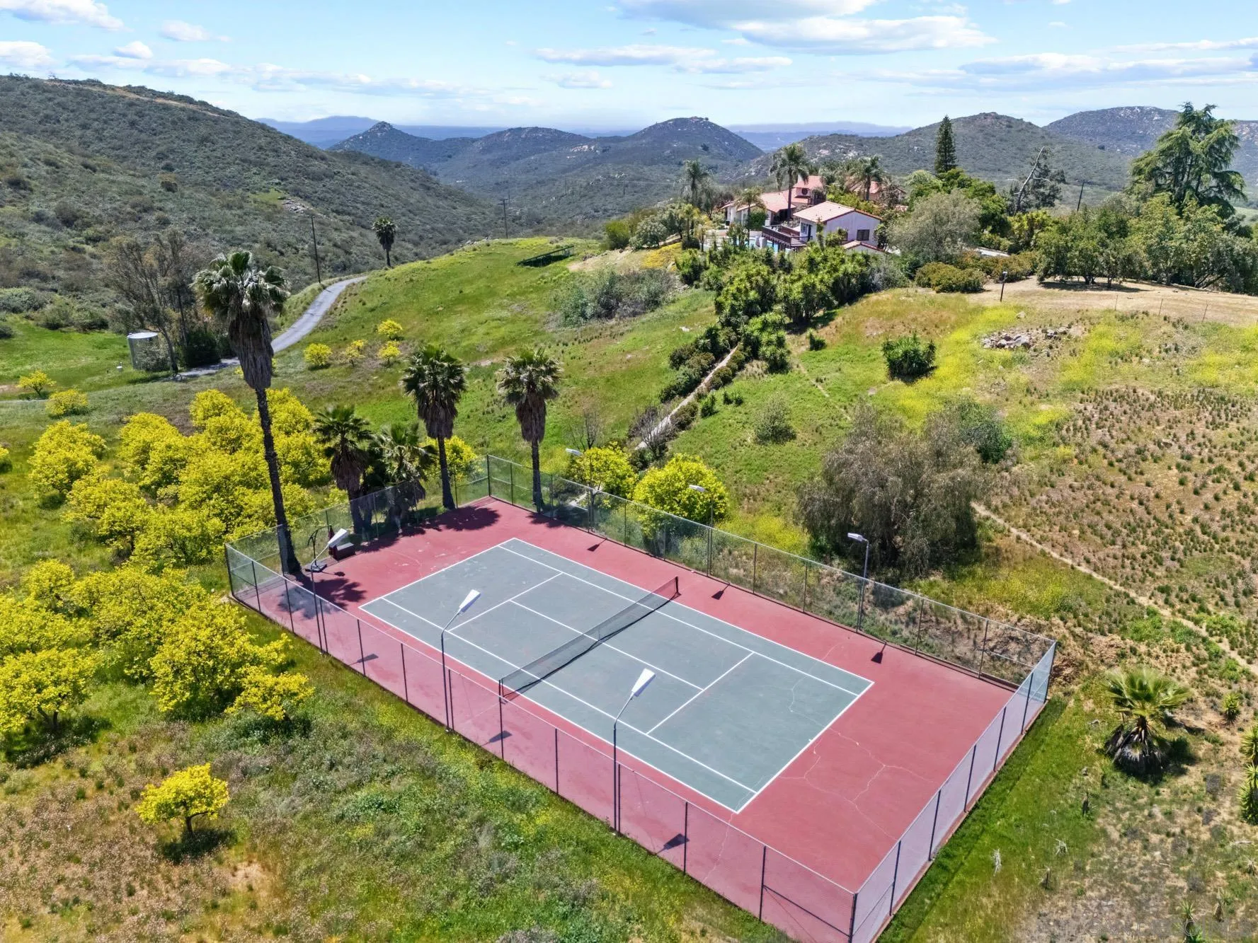 17156 Dos Hermanos Road Poway, CA 92064 - Photo 8 of 59 an aerial view of a tennis ground and a houses