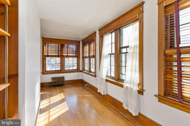 a view of a dining room with furniture large windows and wooden floor