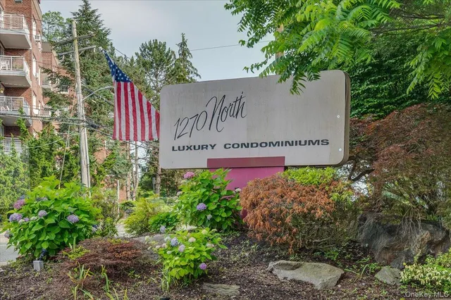 a sign that is sitting in front of flowers