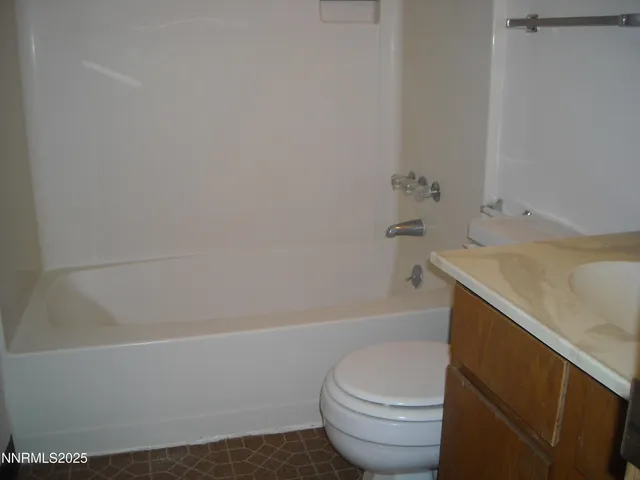 a bathroom with a sink a toilet and bathtub