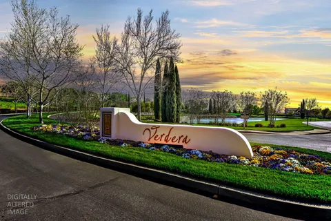 a view of a garden with flower plants and wooden fence