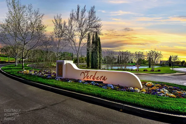 a view of a garden with flower plants and wooden fence