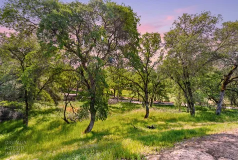 a backyard of a house with a yard and outdoor seating