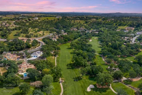 an aerial view of a city with lots of residential buildings and swimming pool