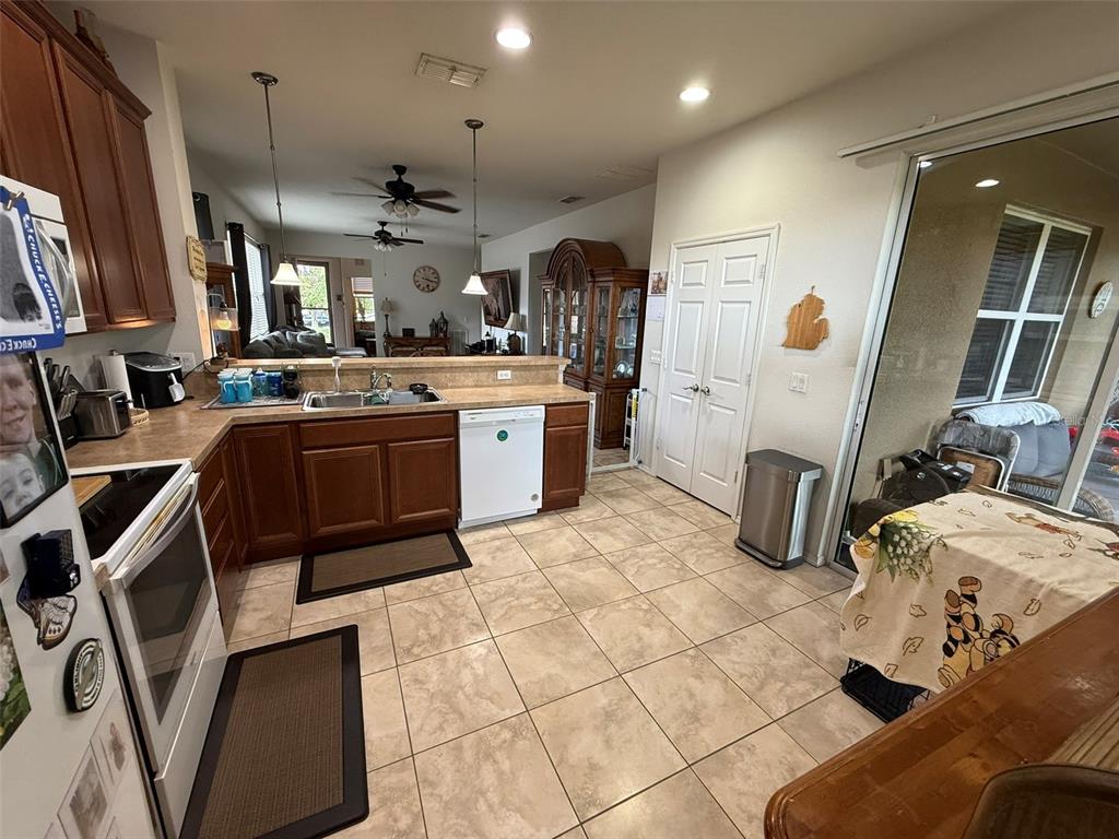 21846 Belgian Court Mount Dora, FL 32757 - Photo 11 of 29 a kitchen with stainless steel appliances granite countertop a sink and a refrigerator
