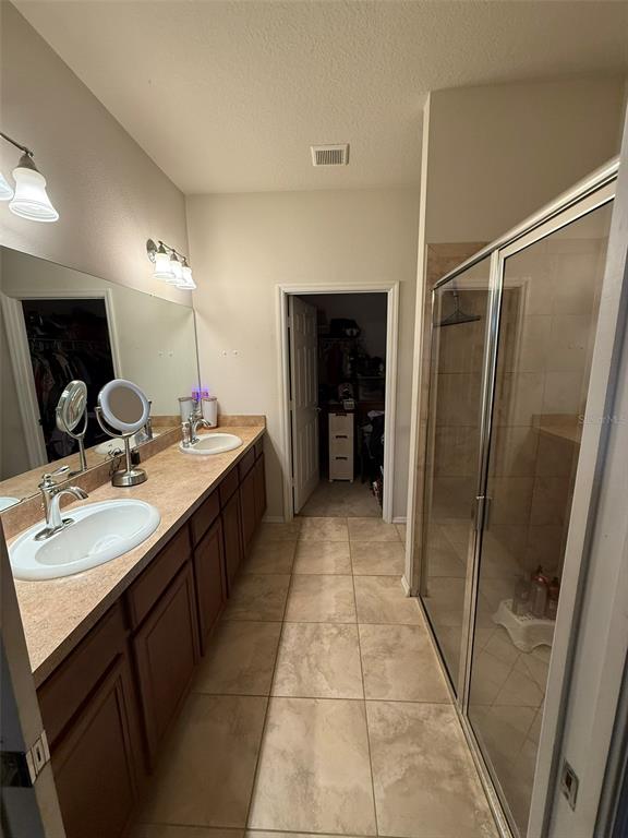 21846 Belgian Court Mount Dora, FL 32757 - Photo 15 of 29 a bathroom with a double vanity sink mirror and shower