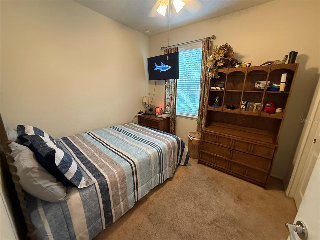 21846 Belgian Court Mount Dora, FL 32757 - Photo 17 of 29 a bedroom with a bed and a night stand