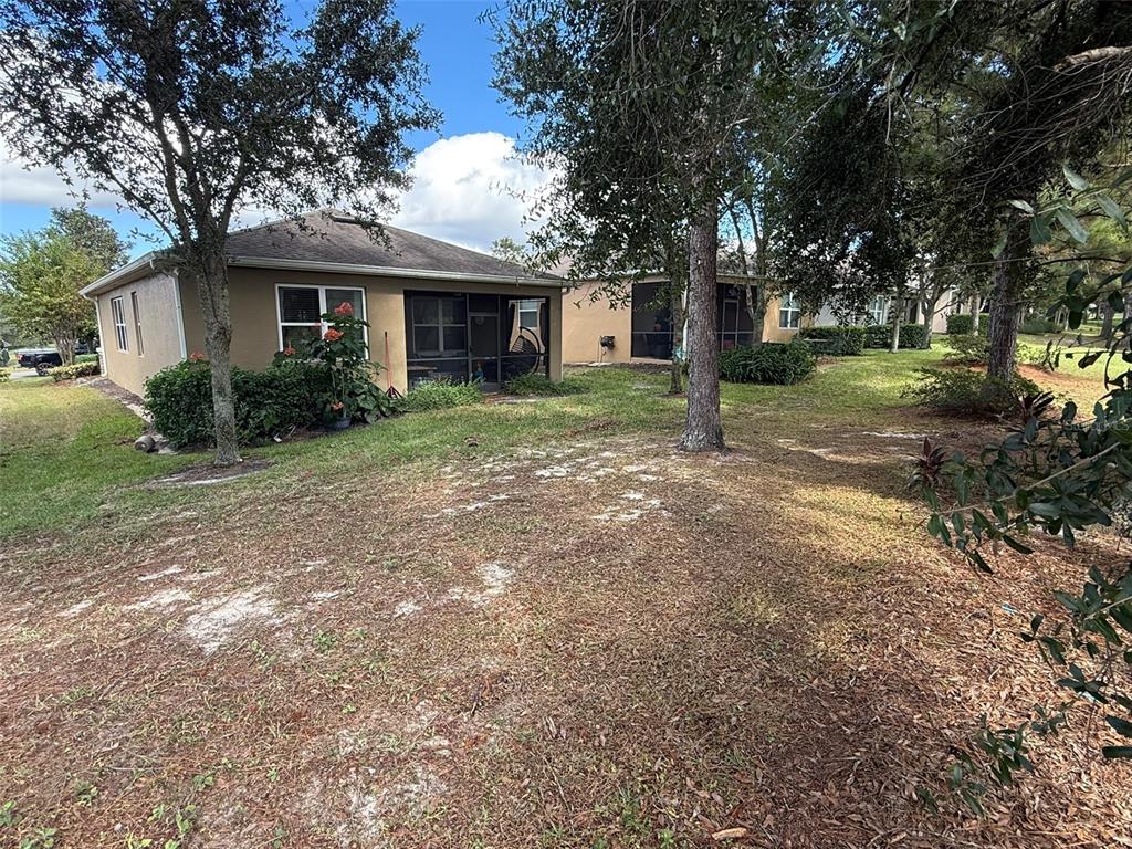 21846 Belgian Court Mount Dora, FL 32757 - Photo 27 of 29 a front view of a house with a yard and garage