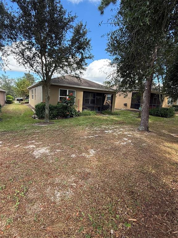 21846 Belgian Court Mount Dora, FL 32757 - Photo 28 of 29 a view of a house with a yard