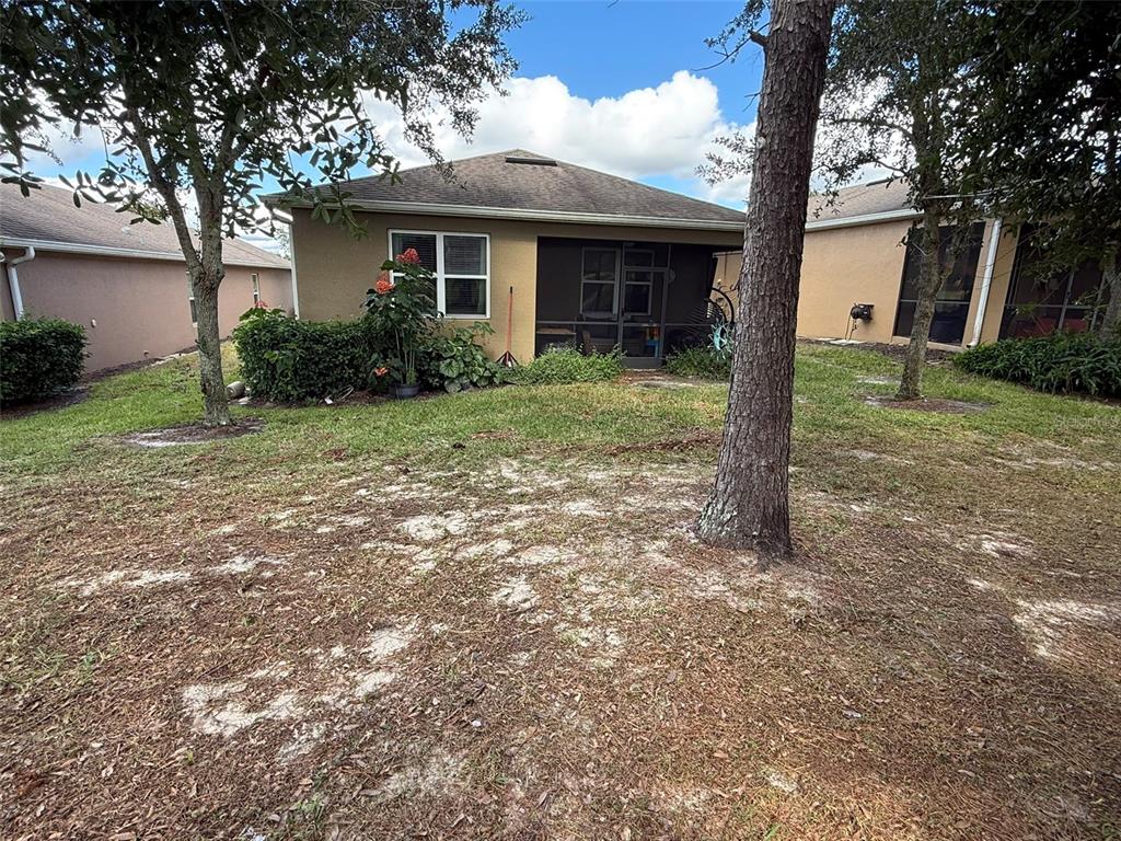 21846 Belgian Court Mount Dora, FL 32757 - Photo 29 of 29 a view of a house with yard and a tree