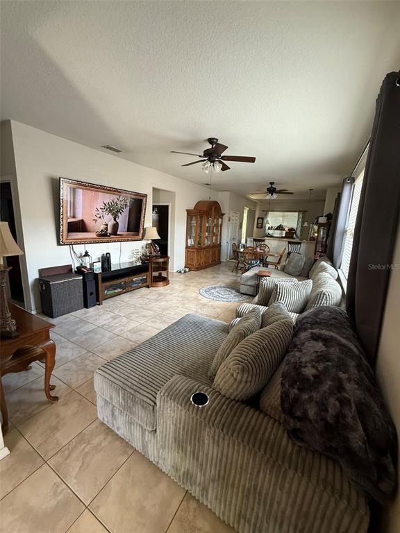 21846 Belgian Court Mount Dora, FL 32757 - Photo 5 of 29 a living room with furniture and a flat screen tv
