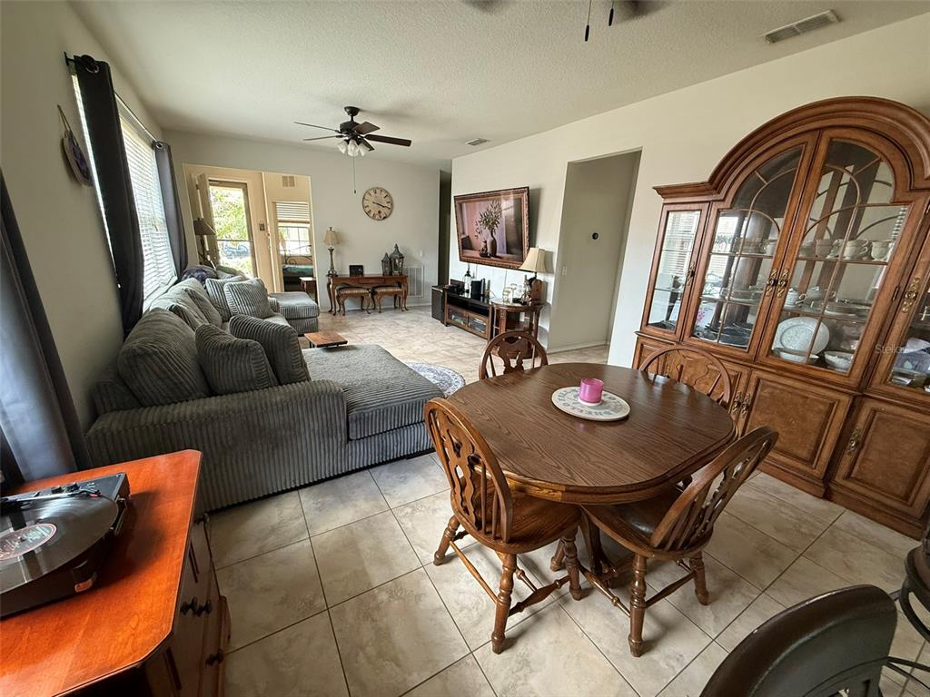 21846 Belgian Court Mount Dora, FL 32757 - Photo 7 of 29 a living room with furniture and a large window