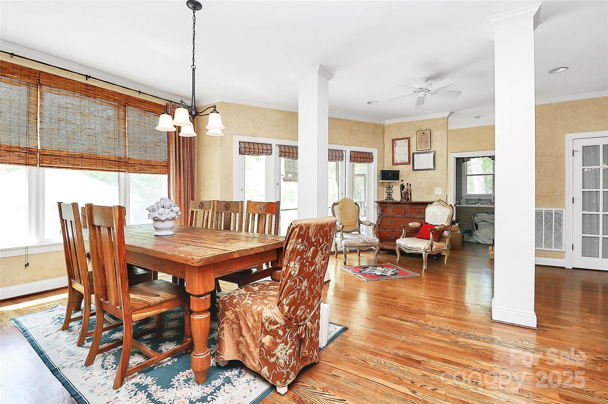 729 Lochaven Road Waxhaw, NC 28173 - Photo 12 of 41 a dining room with furniture wooden floor a rug a potted plant and a chandelier