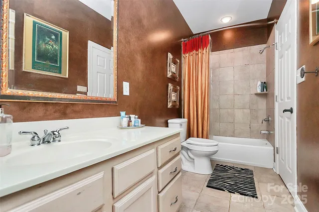 a bedroom with bed and a chandelier