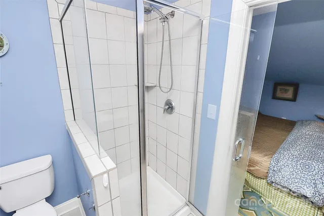 a bedroom with a bed and chair