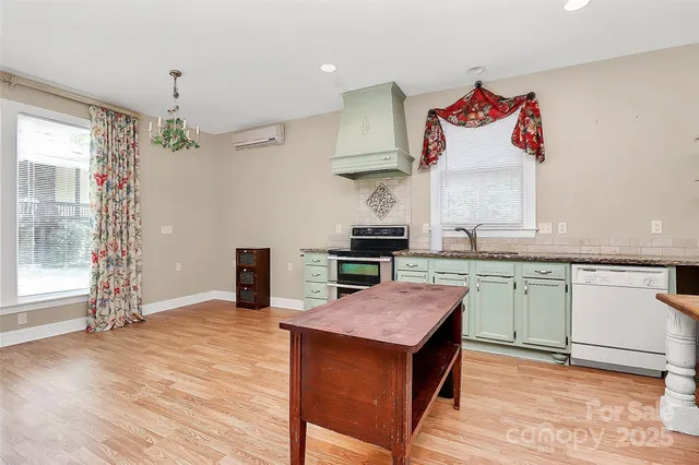 a view of a livingroom with furniture window and wooden floor