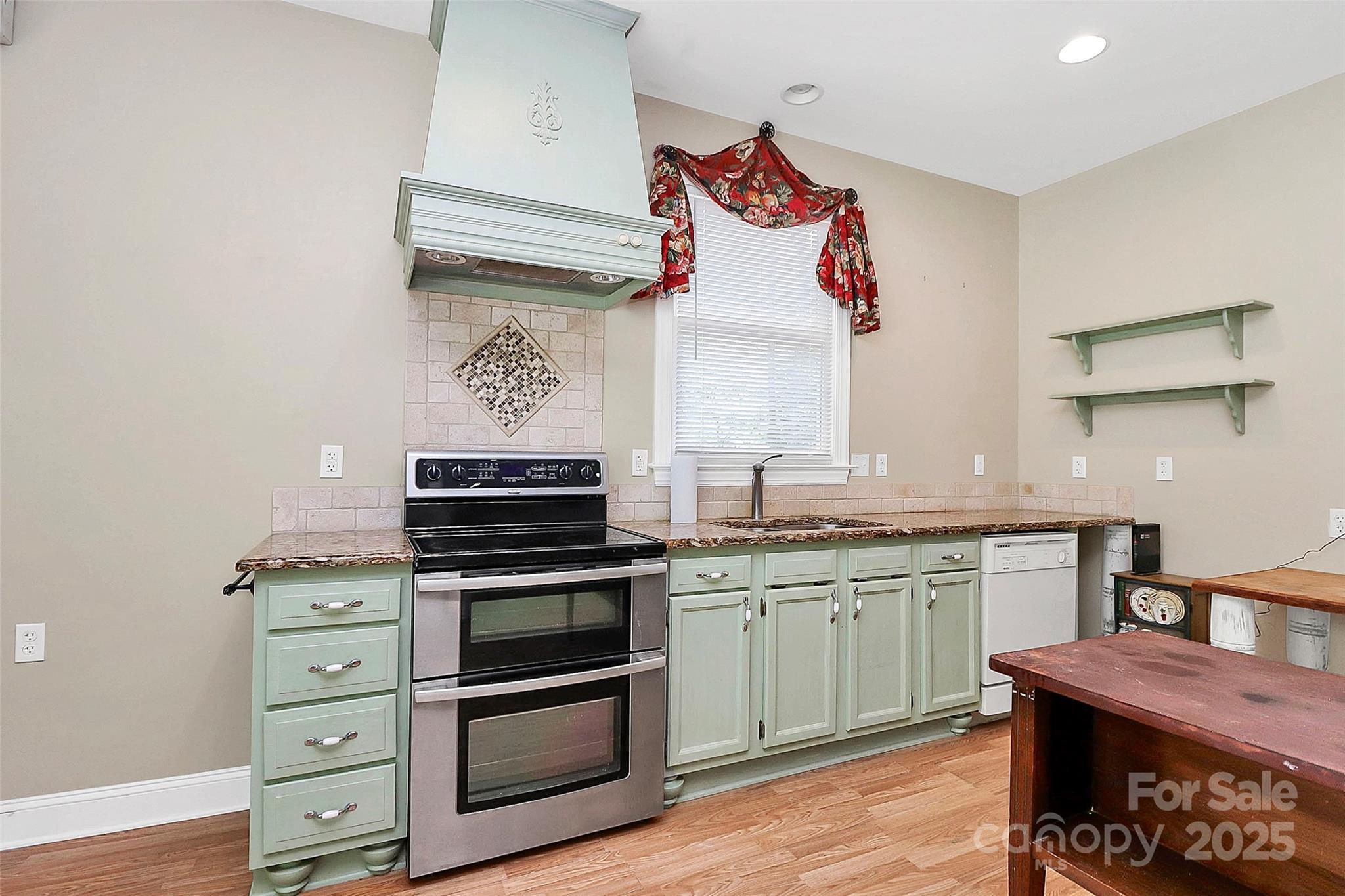 729 Lochaven Road Waxhaw, NC 28173 - Photo 38 of 41 a kitchen with stainless steel appliances granite countertop a stove and a sink