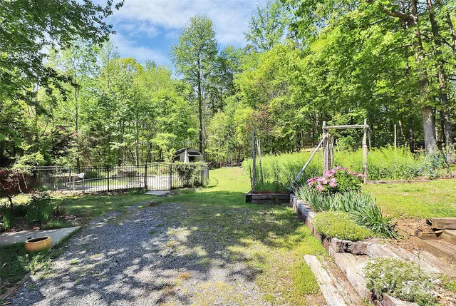 a kitchen with stainless steel appliances granite countertop a sink a stove a refrigerator cabinets and dining table