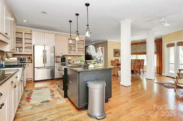 a kitchen with stainless steel appliances kitchen island wooden cabinets and white appliances